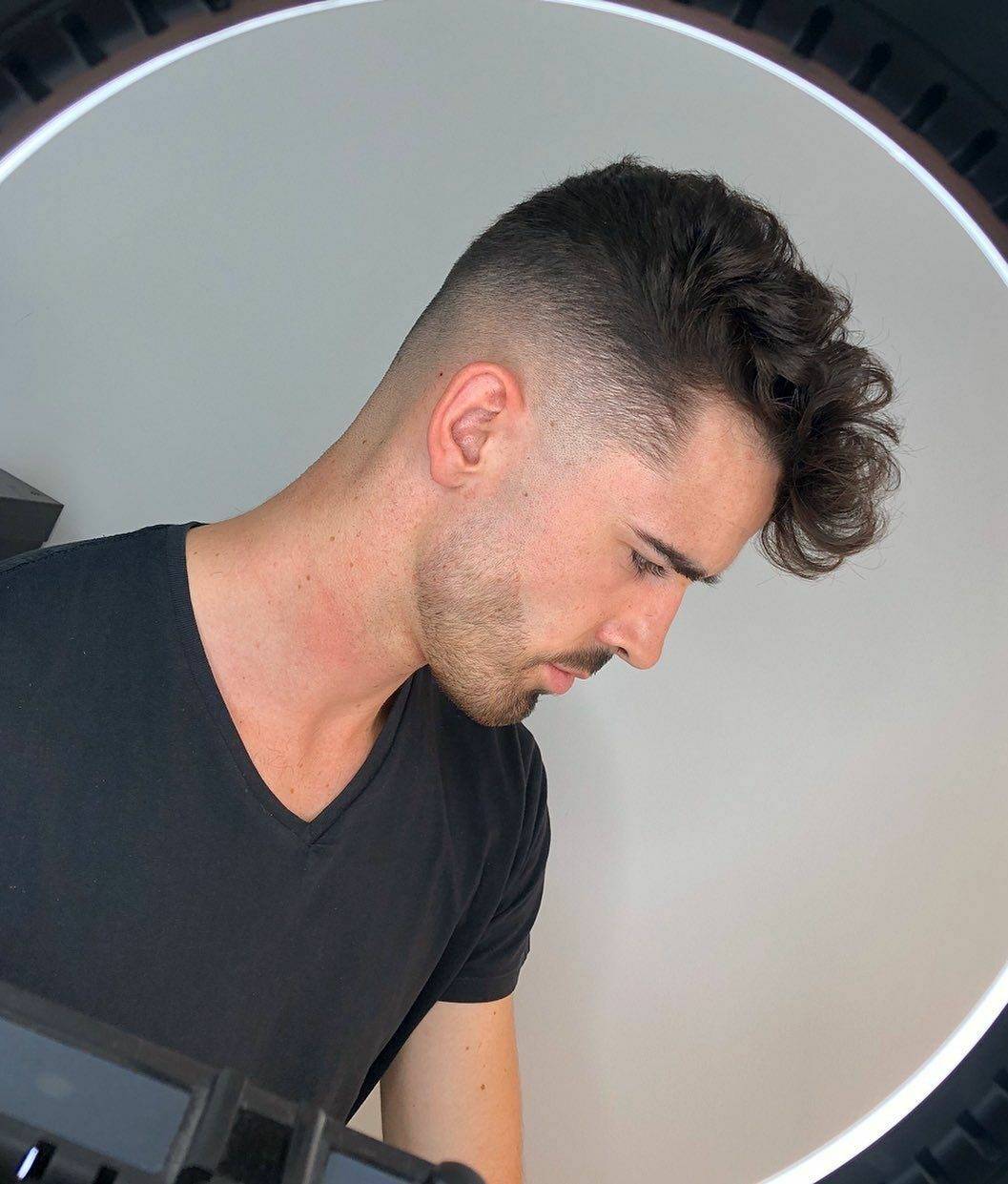 Wavy hair with trimmed beard, ring-light mirror portrait